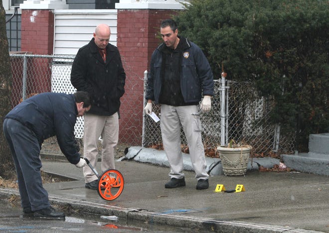 Police collect evidence in front of a house in the Valley neighborhood of Providence Saturday afternoon. A young man was shot in the chest and found sitting on the steps of 40 Health Ave., where he lives, said Sgt. Robert Boehm. Shell casings were found nearby.