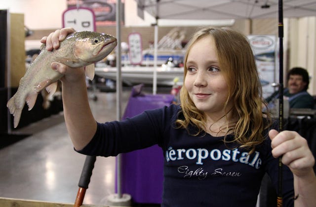 Rachel Rodemann Times Emma Waller, 9, of Eufaula smiles after catching a rainbow trout in the kids fishing pond, Friday, Jan. 17, 2014, during the Arkansas Tackle, Hunting and Boat Show. The event will be open from 10 a.m. to 8 p.m. today and 10 a.m. to 5 p.m. Sunday, with fishing, bull riding, dog shows, giveaways, contests and seminars throughout the weekend.