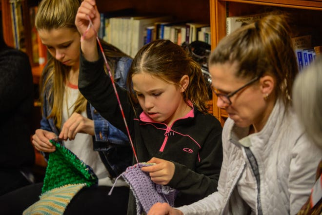Sophia Farina, 8, of New Hope, with here sister Isabella (Left) and mother Cindy, knit blankets during the Delaware Valley Interfaith Council 2014 Martin Luther King, Jr. Day of Service, Sunday, January 19, 2014 at Trinity Episcopal Church in Solebury, Pa.