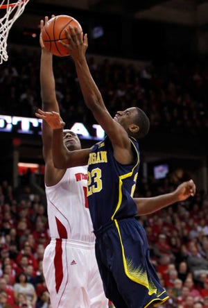 Michigan's Caris LeVert is fouled by Wisconsin's Nigel Hayes on Saturday in Madison, Wis. Michigan upset No. 3 Wisconsin with a 77-70 win.