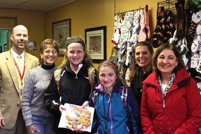 JOHN ADDYMAN | MESSENGER POST

A plateful of fresh, still-warm chocolate chip cookies were delivered to the Sock Nook of the Finger Lakes, a new business at 232 South Main St. in Canandaigua, by representatives of Canandaigua Middle School. From left is Middle School Principal Brian Nolan, Eileen Heil with the Sock Nook, students Lily DeBrock and Maddie Ellison, Kristen Myers with the Sock Nook and teacher Mary Kay Ward.