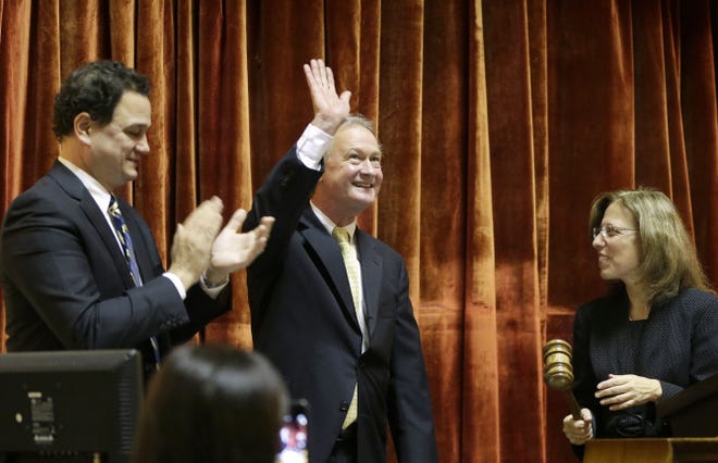 Governor Chafee waves before delivering his State of the State address Wednesday, flanked by Speaker of the House Gordon Fox and Senate President M. Teresa Paiva Weed.