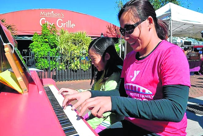 Thuy Nguyen and her daughter, Ashley, play "Heart and Soul" together at one 
of six new, public pianos. The pianos, which were unveiled Friday afternoon, 
are part of the Sarasota Keys public art project. Anyone is welcome to 
play. STAFF PHOTO / SHELBY WEBB