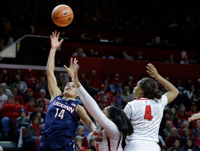 UConn guard Bria Hartley, left, takes a shot Sunday as she drives past Rutgers forward Betnijah Laney, center, and guard Briyona Canty during the first half of their game in Piscataway, N.J. Hartley had 30 points in UConn's 94-64 win.