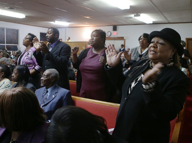 Mary Kershaw sings and claps during a celebration for Dr. Martin Luther King, Jr. at the Greater Friendship M.B. Church in Panama City on Sunday.