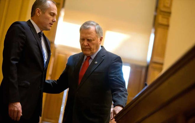 FILE- In this March 28, 2013 file photo, Georgia Gov. Nathan Deal, right, talks with Lt. Gov. Casey Cagle, left, after addressing the Senate on the last day of the legislative session in Atlanta. Politicians take advantage of the last-minute chaos in Georgia's legislative session, seeking to quietly pass legislation that would invite deep scrutiny if there a chance to debate it. Now state Sen. Joshua McKoon, R-Columbus, wants to end last-minute surprises by requiring that lawmakers get at least 24 hours before voting on a bill. (AP Photo/David Goldman, File)