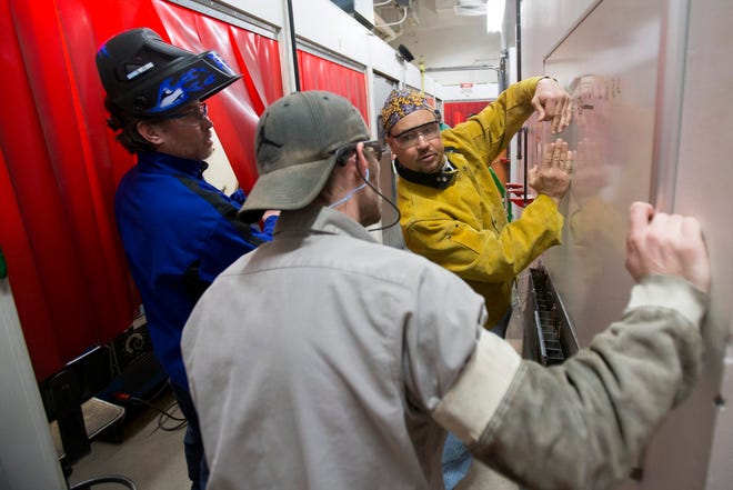 Welding students Jasper Wilson (from left), Jeremiah Johnson and Lee Farber talk before entering welding booths Tuesday, Jan. 21, 2014, at Rock Valley College's Stenstrom Center for Career Education in Rockford.