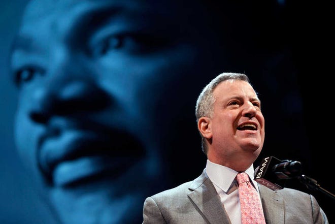 New York City Mayor Bill de Blasio speaks at a tribute to Martin Luther King, Jr. in the Brooklyn borough of New York, Monday, Jan. 20, 2014. De Blasio told a packed audience Monday at the Brooklyn Academy of Music that the "price of inequality has deepened." The mayor says economic inequality is closing doors for hard-working people in the city and around the country. (AP Photo/Seth Wenig)
