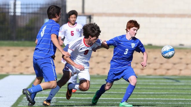 Westlake Defender Nathan Cargnoni (8) and Midfielder Eli Petrick (3) regain control of the ball in Thursday’s Governor’s Cup match against Midway. Photo by René Michaels/gamenightphotos.com