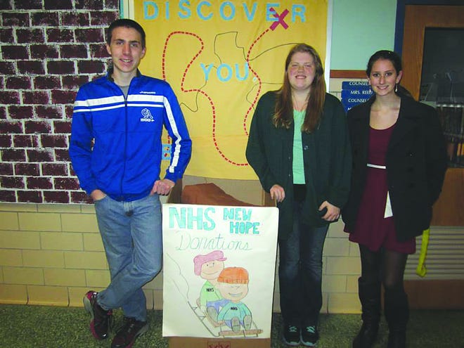 NHS students Ben Hockman, Alex Mowen, and Abby Lakey stand beside the collection box at school and below delivering the donations to New Hope Shelter in Waynesboro.