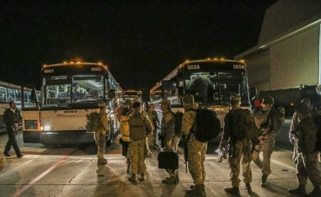U.S. Marines with Marine Medium Tiltrotor Squadron (VMM) 261 board buses on the VMM-261 flight line in preparation of their departure on a nine-month deployment to Afghanistan on Monday.