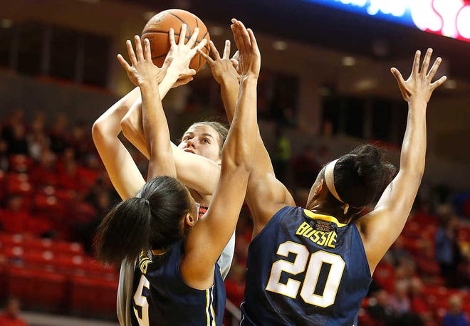 Texas Tech's Haley Schneider is defended by West Virginia's Averee Fields and Asya Bussie during their game on Wednesday in Lubbock. (Stephen Spillman/AJ Media)