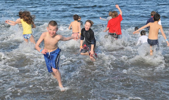 Portsmouth Middle School students take the 2012 Patriot Plunge at Sandy Point Beach in Portsmouth. This year's plunge will take place Sunday, Jan. 26, at 2 p.m.