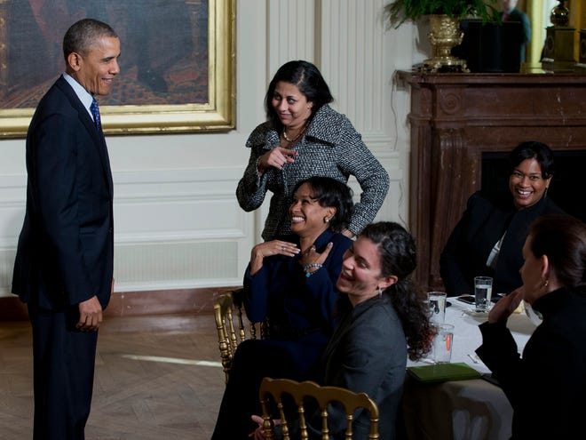 President Barack Obama laughs with women in the East Room of the White House in Washington on Wednesday as he leaves an event for the Council on Women and Girls, where he signed a memorandum creating a task force to respond to campus rapes.