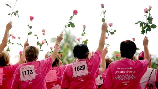 Breast cancer survivors, waving pink roses after the 2012 Komen Race for the Cure in West Palm Beach, also will wear pink shirts and caps at this year’s event, which begins at 7:30 a.m. Saturday on Flagler Drive.