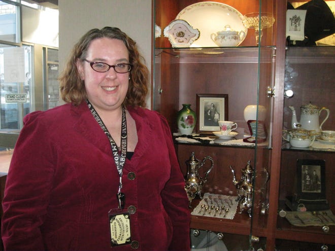 Adult services librarian Laura Warren stands by a display in the lobby at the Fondulac District Library. The display, which contains some of Warren’s personal items, is to promote an upcoming Downton Abbey tea event Feb. 22.