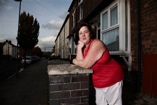 In this photo provided by Channel 4 on Tuesday, Jan. 21, 2013, 'White Dee' featured in the show Benefits Street, poses for a promotional still. The stars of Britain's most talked-about television show have a dubious claim to fame: They don't work. A shoplifter running away from police, a recovering drug addict and a ragtag band of jobless people are the unlikely stars of "Benefits Street," a hit documentary-style program about welfare receipients that has drawn millions of viewers and stirred up a furious storm of complaints and controversy in Britain. Critics say the show _ which zooms in on the residents of a Birmingham street where 9 out of 10 people are said to live off state payouts _ is designed to fan hatred by showing people on the dole in the worst possible light. Scores of viewers took to Twitter to vent abuse at the residents as soon as the first episode aired earlier this month, and some even made death threats. (AP Photo/Channel 4, Richard Ansett)