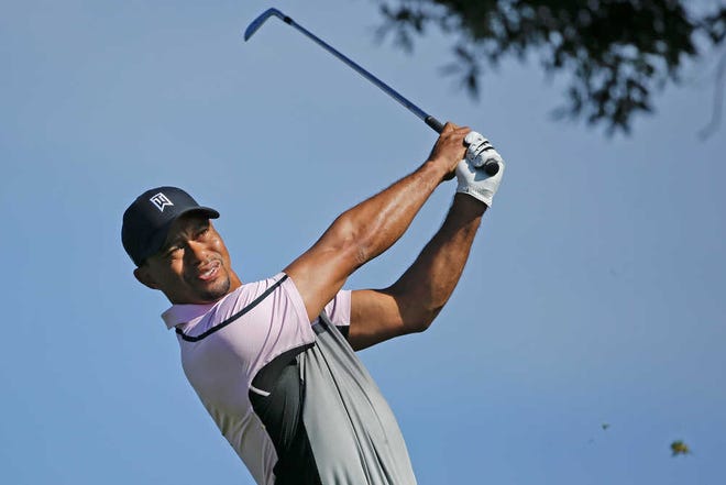 Tiger Woods watches his tee shot on the par-3 third hole on the South Course at Torrey Pines during the first round of the Farmers Insurance Open golf tournament Thursday, Jan. 23, 2014, in San Diego. Woods made par on the hole. (AP Photo/Lenny Ignelzi)