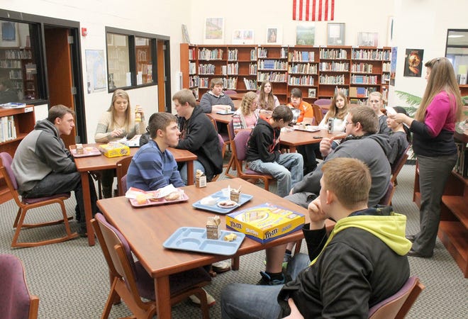Jonesville High School librarian Linda Quiggle talks with members of M8KN IT MNE about plans for upcoming events during a meeting Tuesday. The group works to promote the school's library.
