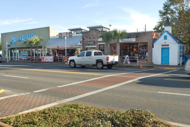 Shoppers stroll along U.S. Highway 98 in downtown Fort Walton Beach. City officials are considering establishing an entertainment district to attract more people to the area.