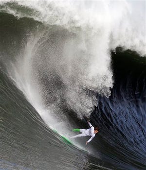 Nic Lamb begins to fall off his board during the third heat of the first round of the Mavericks Invitational big wave surf contest Friday, Jan. 24, 2014, in Half Moon Bay, Calif. (AP Photo/Eric Risberg)