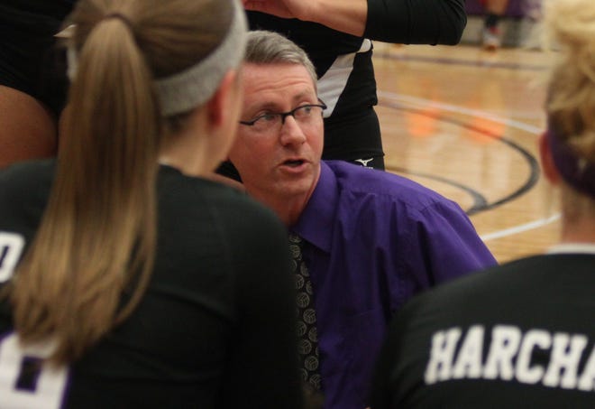 Lincoln College women's coach Mark Tippett huddles with the team during a timeout. He will also coach the new men's volleyball club. Photo by Bill Welt/The Courier