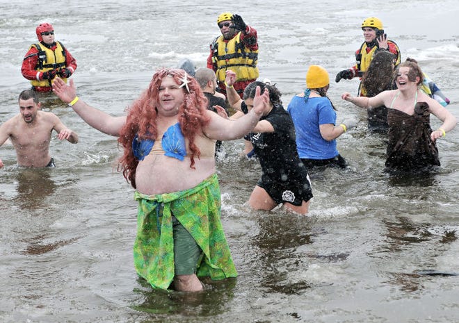 A polar plunger hams it up for the crowd as hundreds take a plunge into the Delaware River Saturday to raise money for Special Olympic athletes during the 6th Annual Eastern Polar Plunge at Neshaminy State Park in Bensalem.