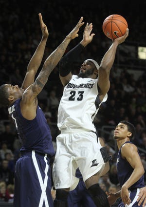 PC’s LaDontae Henton gets a jump on Xavier’s Jalen Reynolds on Saturday at The Dunk.