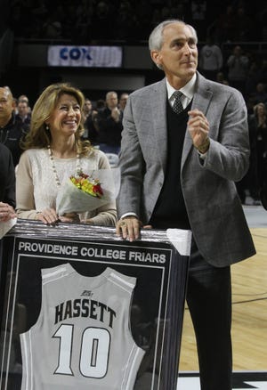 Friars great Joe Hassett stands next to his jersey during a halftime ceremony at Saturday’s PC-Xavier game at the Dunkin’ Donuts Center. Hassett’s number was retired, along with those of fellow Friars Kevin Stacom and Tracy Lis. ?