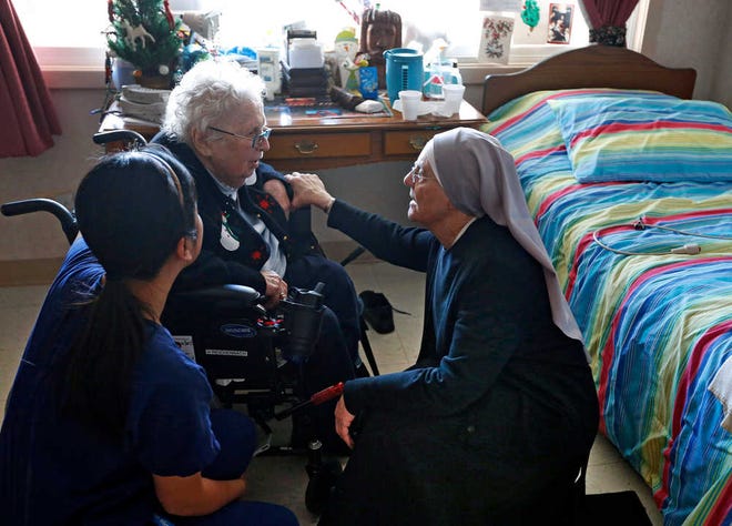 Mother Patricia Mary, right, and nurse Friary Nguyen visit 99-year-old resident Helen Reichenbach in her room at the Mullen Home for the Aged, run by Little Sisters of the Poor, in Denver, Thursday Jan. 2, 2014. Acting at the request of Little Sisters of the Poor, Justice Sonia Sotomayor on Tuesday Dec. 31, 2013, temporarily blocked the Obama administration from forcing some religious-affiliated groups to provide health insurance coverage of birth control or face penalties as part of the Affordable Care Act. The stay was issued just hours before the requirement was to go into effect on New Year's Day. (AP Photo/Brennan Linsley)