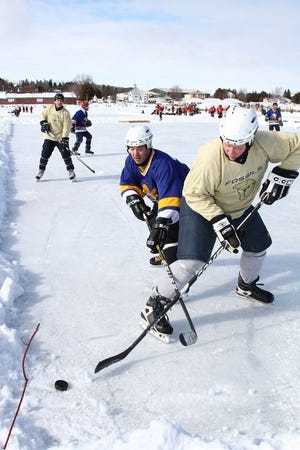 Some of the action experienced on the ice of Lake Huron during the 2013 Labatt Blue Adult Pond Hockey Championship in St. Ignace.