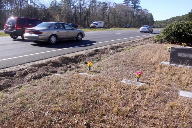 Scott Thompson/Bluffton TodayTraffic on U.S. 278 rolls past graves in Indian Hill Baptist Church's cemetery in Okatie on Monday. The church's pastor is hoping the SCDOT can build a guard rail along the edge of the road to protect the graves from cars potentially running off the road.