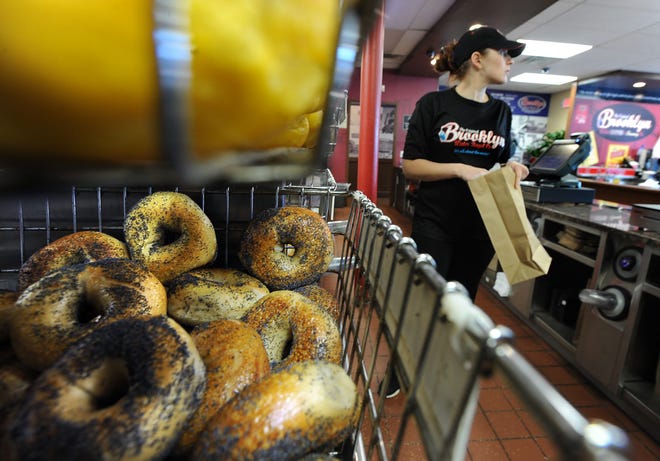 At the Original Brooklyn Water Bagel Co. in Framingham, employee Johanna Favaro fills a customer's bagel order. WICKED LOCAL STAFF PHOTO/ ALLAN JUNG