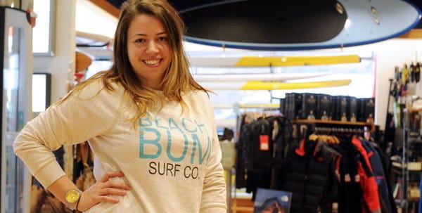 Candace Bouffard shows some of her Beach Bum Surf Co. apparel at Mocean in Mashpee Commons.