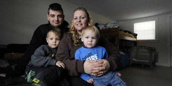 Krista Hansen and Michael Byron have been living at the Village at Cataumet since Nov. 1, with sons Matthew Byron, 4, (bottom left) and Noah Byron, 17 months, (bottom right). The are photographed in their one room unit. Cape Cod Times/Merrily Cassidy
CATAUMET -- 011014 -- Krista Hansen and Michael Byron have been living at the Village at Cataumet since Nov. 1, 2013, with Matthew Byron, 4, (bottom left) and Noah Byron, 17 months, (bottom right). The are photographed in their one room unit.