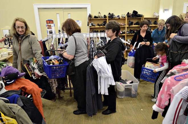 A line of shoppers wait to checkout during a rummage sale at Temple Judea in Doylestown Township. $aving Bucks explored the "art" of rummaging and how to find the best deals.