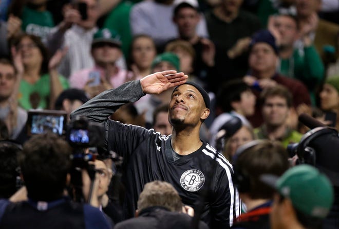 Nets forward Paul Pierce salutes the Boston crowd as the Celtics pay tribute to their former captain with a video montage during Brooklyn's 85-79 win over the Celtics on Sunday night.