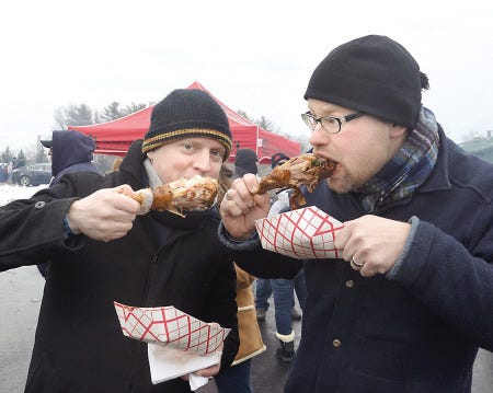 Chowing down some grilled turkey legs from the Meat House at the Polar Grillfest at Redhook Brewery Saturday are Eric Lavolod of Portsmouth and Erik Hegre of Boston.