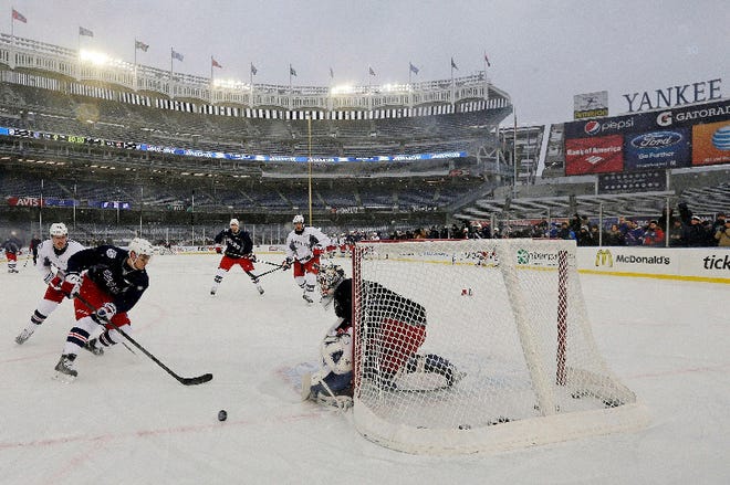 New York's Chris Kreider, left, attempts to score on goalie Cam Talbot during the Rangers' practice Saturday for today's game against the New Jersey Devils at Yankee Stadium.