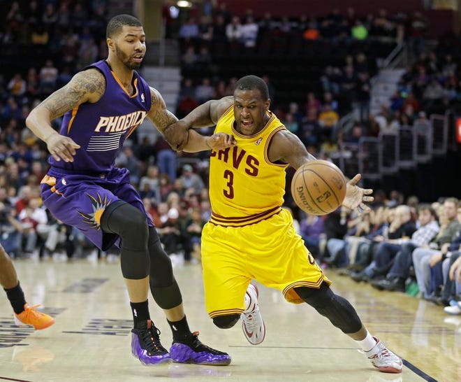 Cleveland's Dion Waiters loses the ball under pressure from Phoenix's Markieff Morris in the second quarter of Sunday's game in Cleveland.