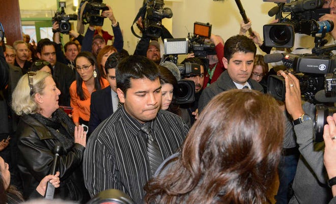 Erick Munoz, husband of Marlise Munoz, is escorted out of court by his attorney Heather L. King, right, Friday, Jan. 24, 2014 in Fort Worth, Texas. The court ruled in Munoz's favor and to remove his brain-dead pregnant wife from life support. Judge R. H. Wallace Jr. issued the ruling in the case of Marlise Munoz. John Peter Smith Hospital in Fort Worth has been keeping Munoz on life support against her family's wishes. The judge gave the hospital until 5 p.m. CST Monday to remove life support. (AP Photo/Tim Sharp)