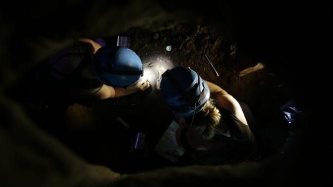 Becca Peixotto, left, and Marina Elliot excavate bones in the Rising Star fossil chamber. COURTESY OF MARINA ELLIOT