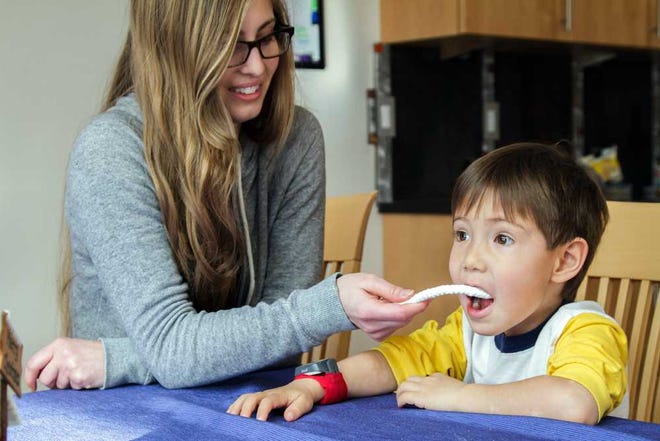 This handout photo provided by University of Colorado, Boulder, taken Dec. 20, 2013, shows University of Colorado, Boulder, student Karlie Johansen collecting a saliva sample from 3-year-old Anders Todd, as part of a study of sleep patterns in young children. In an earlier study, researchers reported that if young children continually struggle to fall asleep at night, it might be because their body clock is out of sync with their bedtime. (AP Photo/Miranda Fan, University of Colorado)