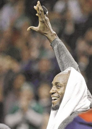 Kevin Garnett waves to the Boston crowd during a tribute to him on Sunday night.