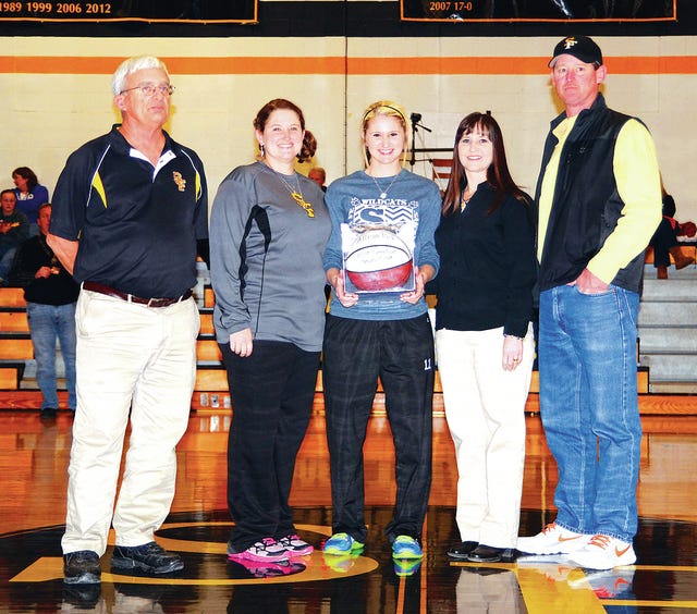 Santa Fe senior Allison Pack was presented her 1,000th-point basketball. Pictured from left are head coach: Parks Gettys, assistant coach Amy Stricklin, Pack and her parents Danette and Ronnie Pack. (Photo by correspondent Ric Beu).