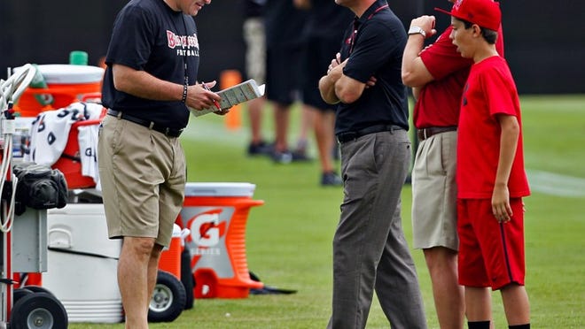 Head coach Greg Schiano, general manager Mark Dominik and director of player personnel Dennis Hickey talk during Tampa Bay Buccaneers rookie mini-camp. (DANIEL WALLACE, Tampa Bay Times)