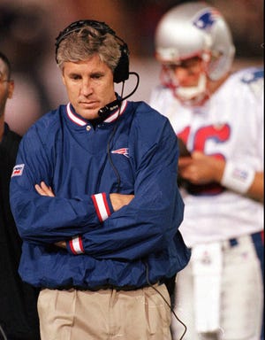 ORG XMIT: New England Patriots coach Pete Carroll paces the sidelines in the fourth quarter of the Denver Broncos 34-13 victory over the Patriots at Mile High Stadium in Denver on Monday night, Oct. 6, 1997. Patriots reserve quarterback Scott Zolak reads a clipboard at right. (AP Photo/David Zalubowski)