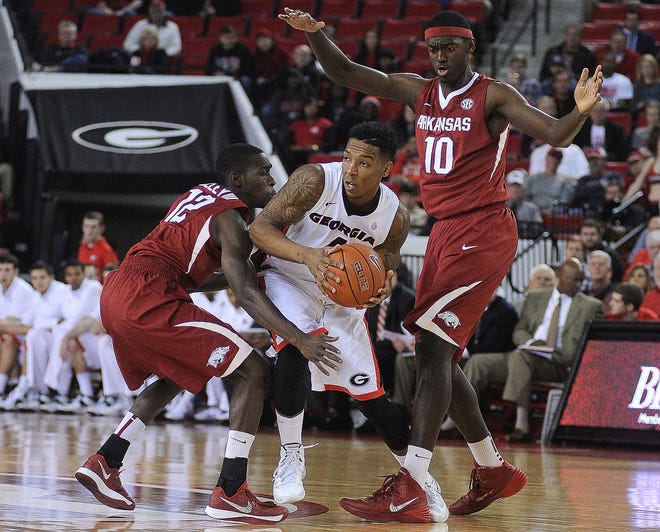 Arkansas’ Fred Gulley III (12) and Bobby Portis (10) double-team Georgia’s Charles Mann during a game on Jan. 18. If Missouri hopes to come away with a victory tonight at Bud Walton Arena, the Tigers will have to handle the pressure of Mike Anderson’s Razorbacks.