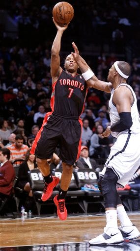 Toronto Raptors guard Kyle Lowry (7) shoots over the defense of Brooklyn Nets forward Paul Pierce (34) in the second half of their NBA basketball game at the Barclays Center, Monday, Jan. 27, 2014, in New York. The Raptors defeated the Nets 104-103. (AP Photo/Kathy Willens)