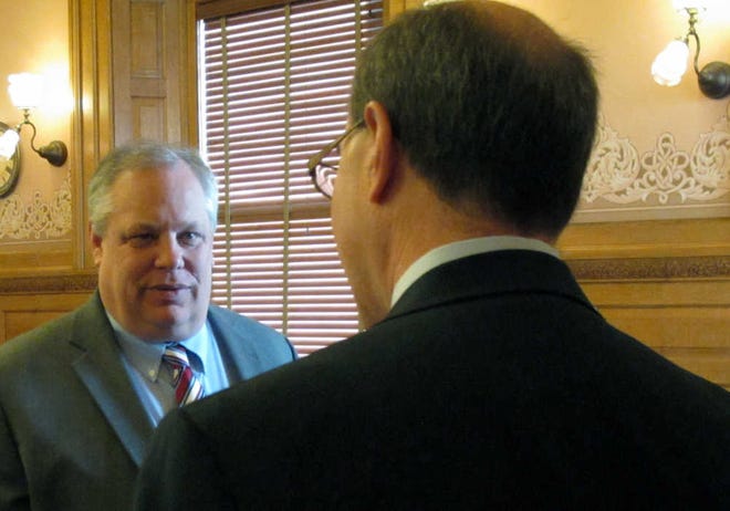 Tom Witt, left, executive director of the gay-rights group Equality Kansas, confers with Kansas state Rep. Steve Brunk, a Wichita Republican, before a committee hearing on gay marriage Tuesday at the Statehouse. Brunk is chairman of the committee hearing a bill that Witt and his group opposes.